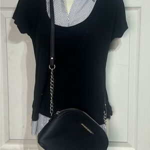 This is a Steve Madden black dome crossbody bag featuring silver hardware